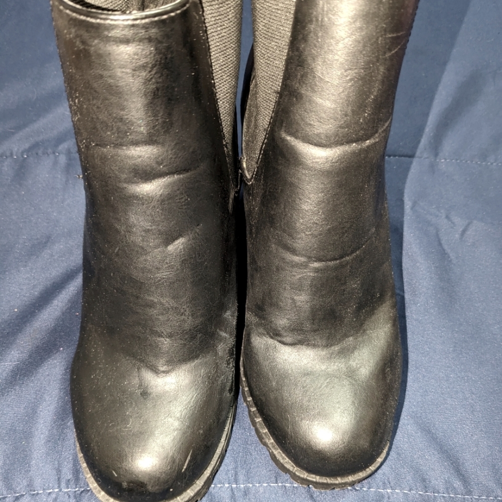 Distressed black Chelsea boots with three and a half inch block heel lug soul